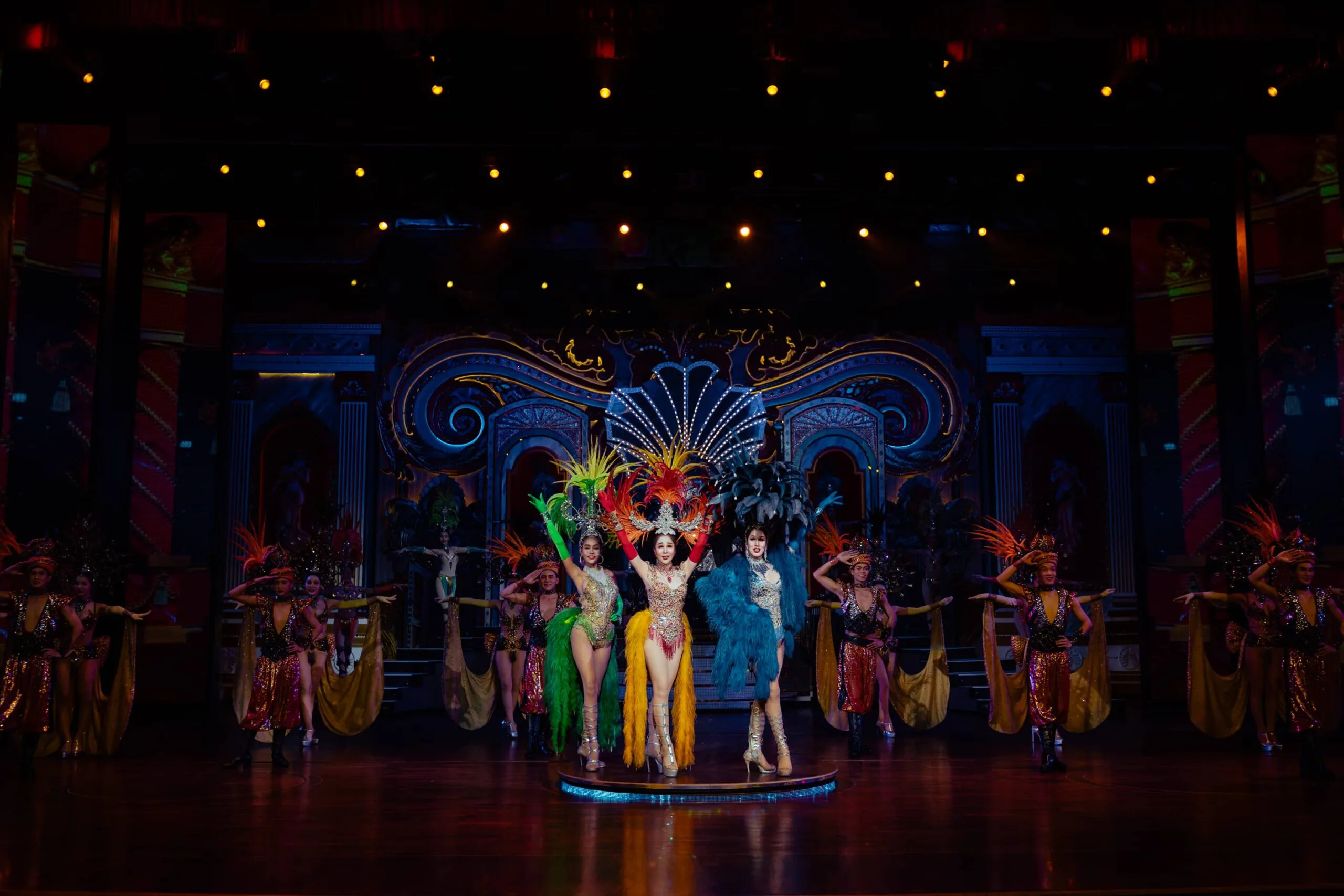 Performers in elaborate costumes on stage at the Alcazar Cabaret Show in Pattaya