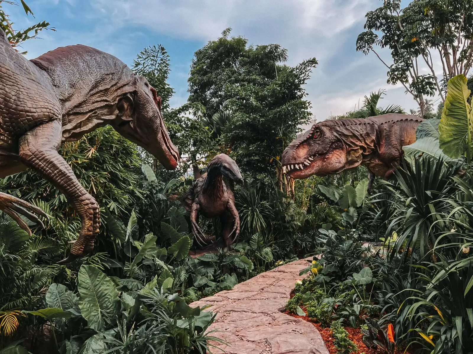 Life-size dinosaurs along the mini-golf trail at Dino Park Phuket